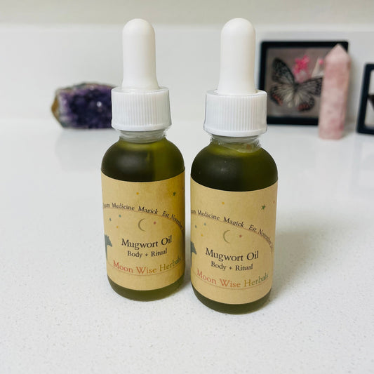 Two bottles of Mugwort Oil from Moon Wise Herbs on a white surface.